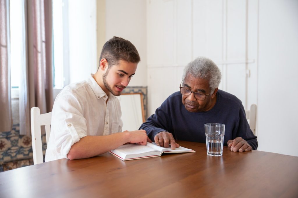 man reading a book with elder