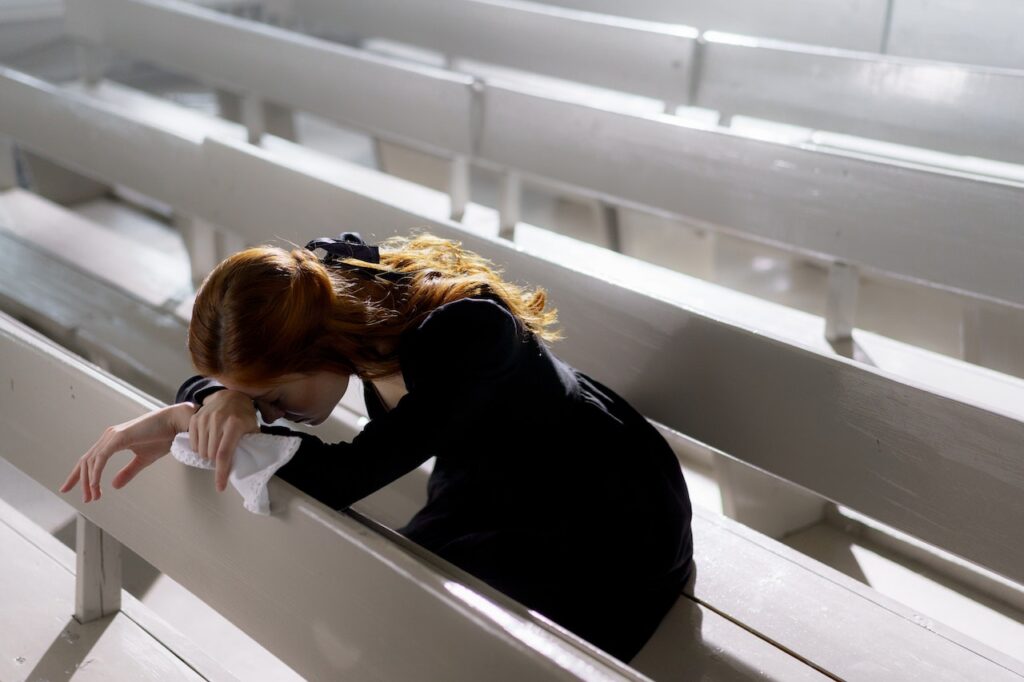 woman crying in church