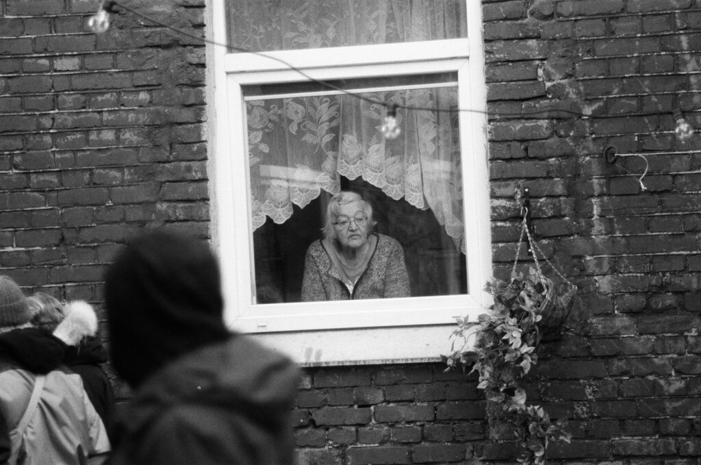 elderly looking outside the window
